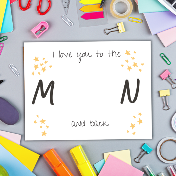 grey desk with paperclips, post-it notes, highlighters, paper Love you to the Moon and Back with start handprint art