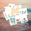ocean coming up on the sand with printables of summer handprints shown from ice cream, flip flops, crab, pineapple, watermelon