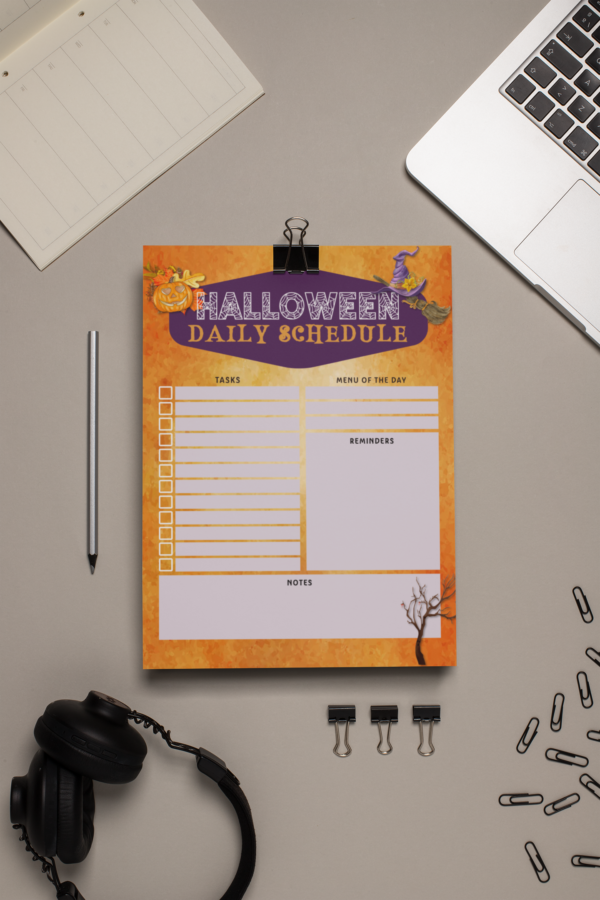 Halloween daily schedule page clipped on a desk