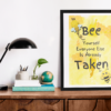 Bee Yourself poster framed on a desk