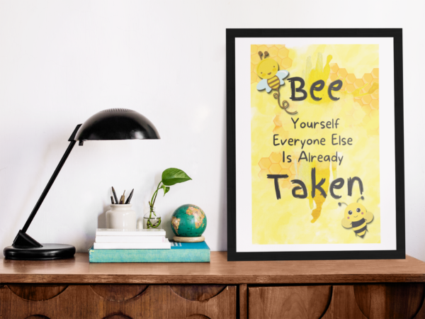 Bee Yourself poster framed on a desk