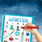 Wintery Star Background with Winter BINGO board with winter images with a child hand with marker marking them off
