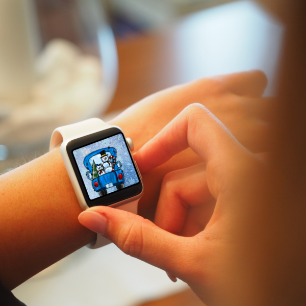 person has a watch on its wrist with display on with Snowman Apple Watch Wallpaper with blue watch with blue wallpaper and snowflakes with a blue truck with two snowmen in the back with a candy cane and a tree