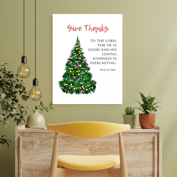 Christmas scripture wall art featuring Psalm 136 verse one above a desk.
