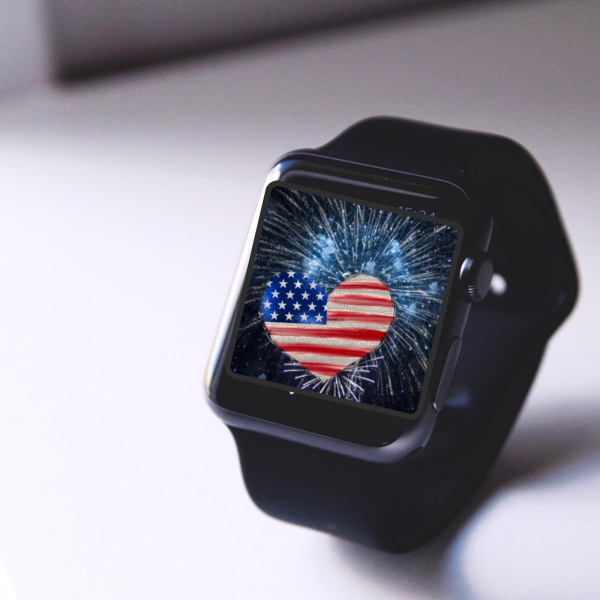 white desk sitting with an Apple Watch with blue fireworks on the background with leopard American heart flag