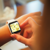 shows wrist of someone on an Apple Watch with bees and sparkle glitter sunflowers on the background wallpaper