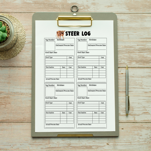 wood table with pen and clipboard with Steer Log on clipboard
