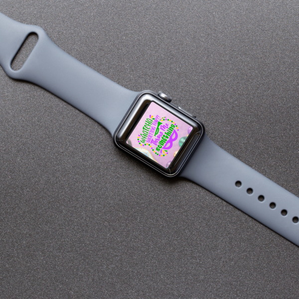gray table top with gray Apple Watch on it showing Mardi Gras watch wallpaper