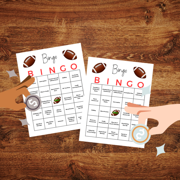 table with two hands holding coins to cover the next square of the football bingo card.