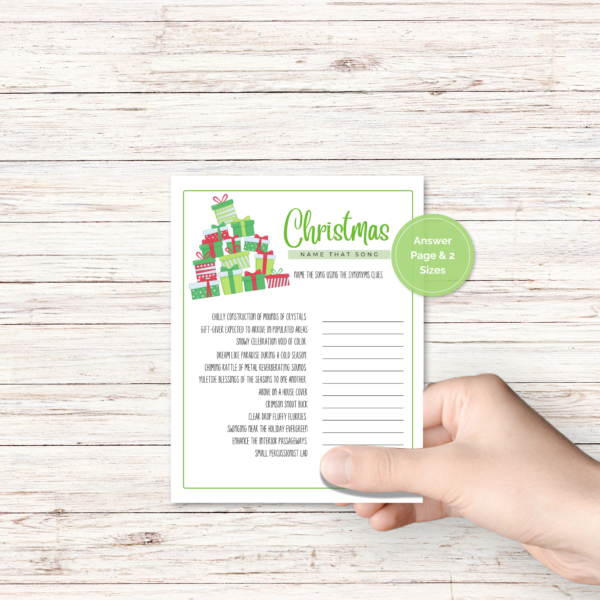 wood background, with a hand holding the winter party game with presents with green border, has a green dot that says answer page and 2 sizes.