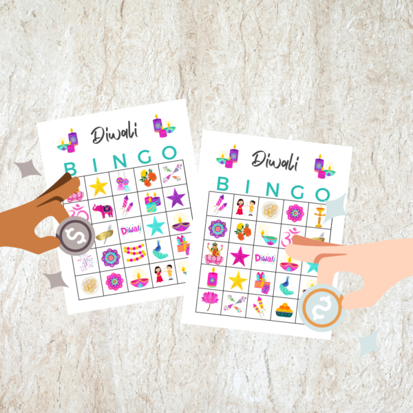 marble counter top with 2 hands ready to play Diwali Bingo with the markers ready to place