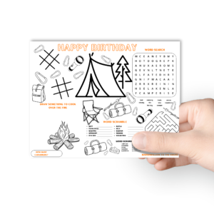 white background, with hand holding the birthday camping placemat