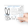 hand holding the happy birthday activity beach themed mat, maze, word search, drawing, coloring, word scramble,
