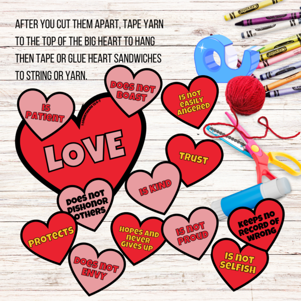 wood background, crayons, tape, yarn, scissors, and glue stick on table. Says after you cut them apart, tape yarn to the top of the big heart to hang, then tape or flue heart sandwiches to string or yarn. Shows colored cut out pieces on the table.