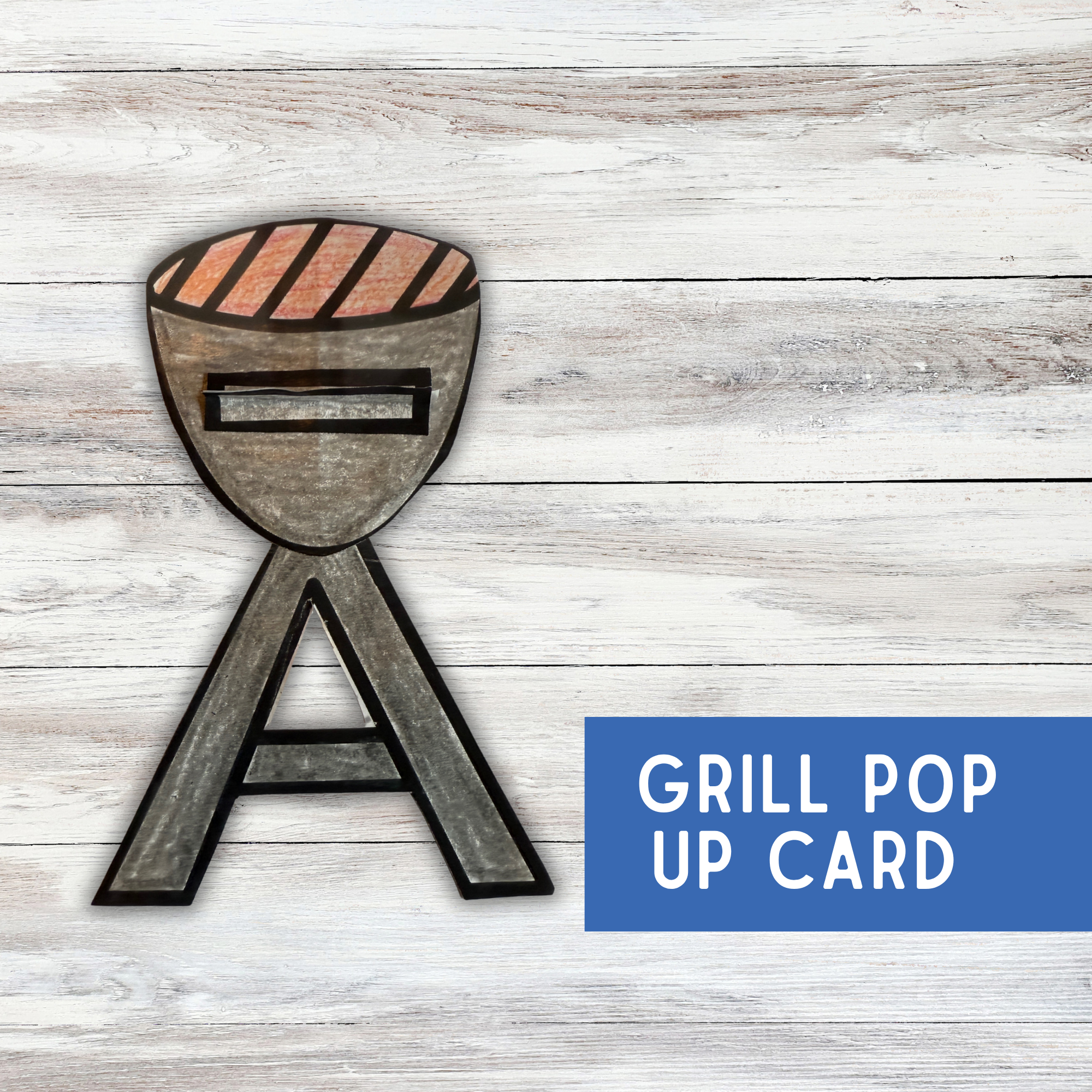 shows grill on a wood table that has been color and cut out, says grill pop up card